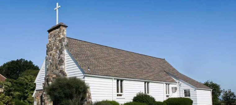 church with gray roof under blue sky