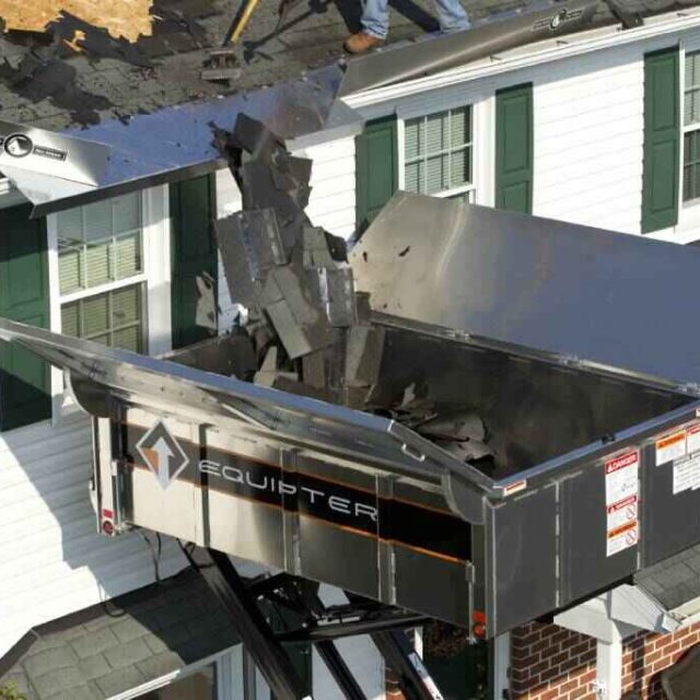 roofing material being thrown into Equipter roof buggy