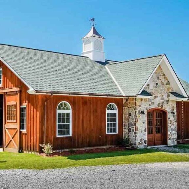 wood home with shingle roof with cupola with blue sky