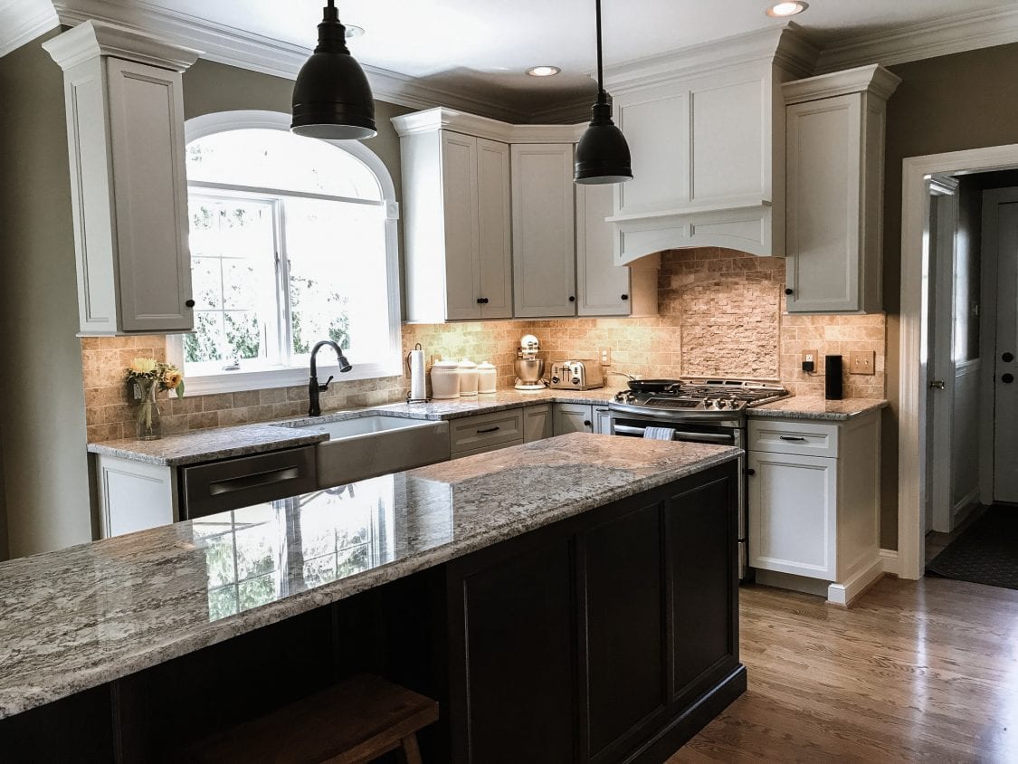 Modern kitchen with grey granite countertops and white cabinets