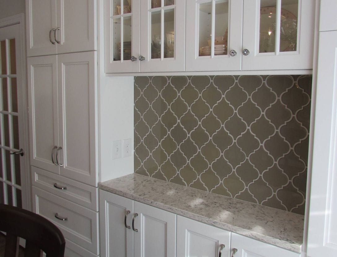 Wet bar in kitchen with white cabinets