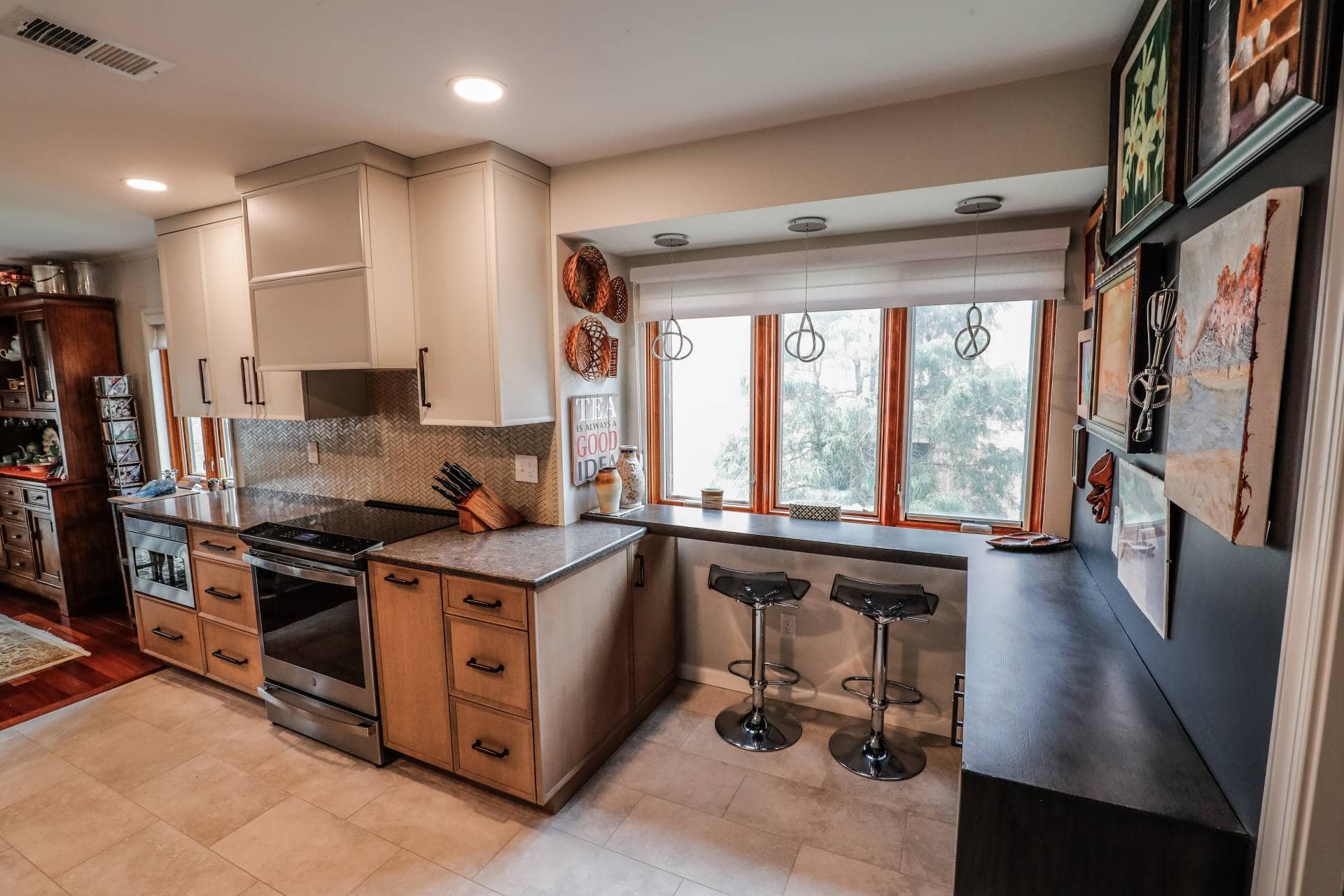 three large windows in the front of a bar in a spacious kitchen remodel