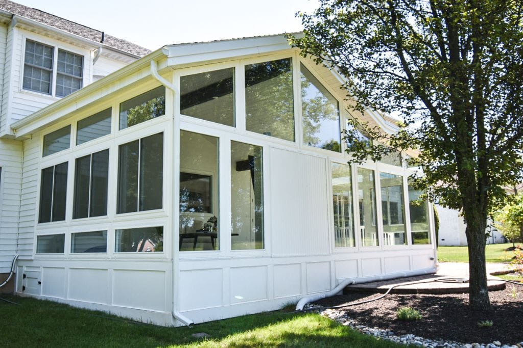 Modern sunroom exterior designs with white windows and trim