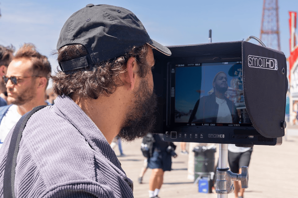 An image of a man looking at the recorded screen
