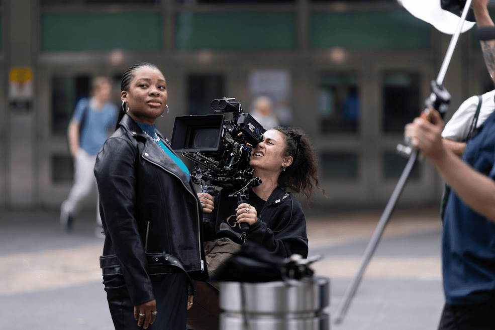 a person with a camera capturing an individual