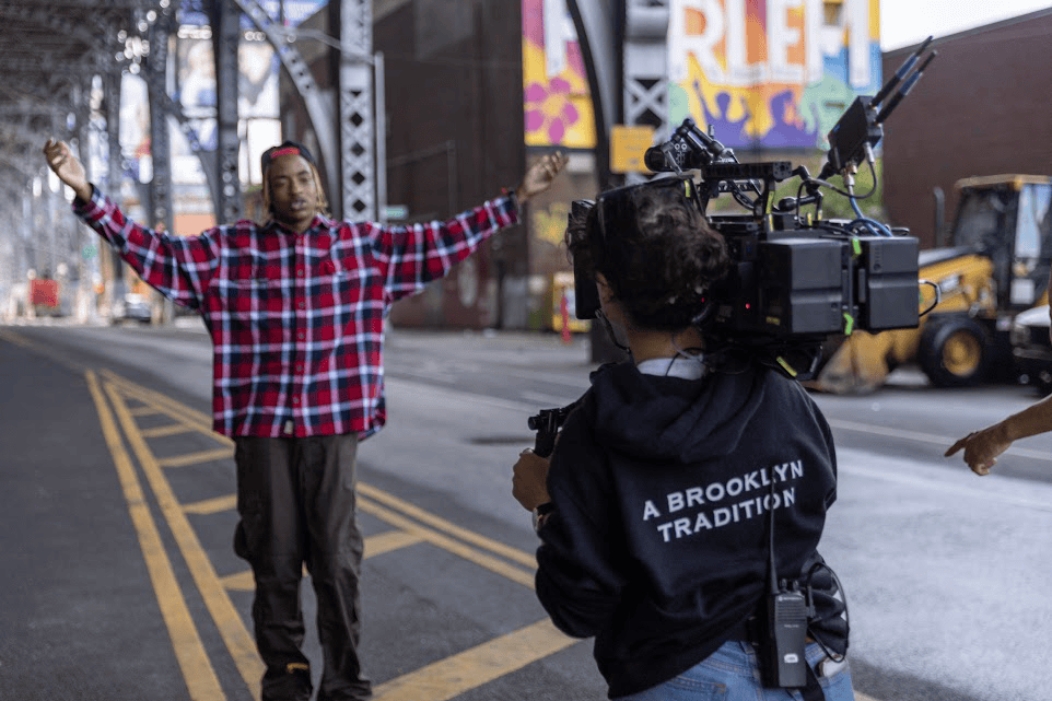 An image of a camerawoman filming a guy for a short video