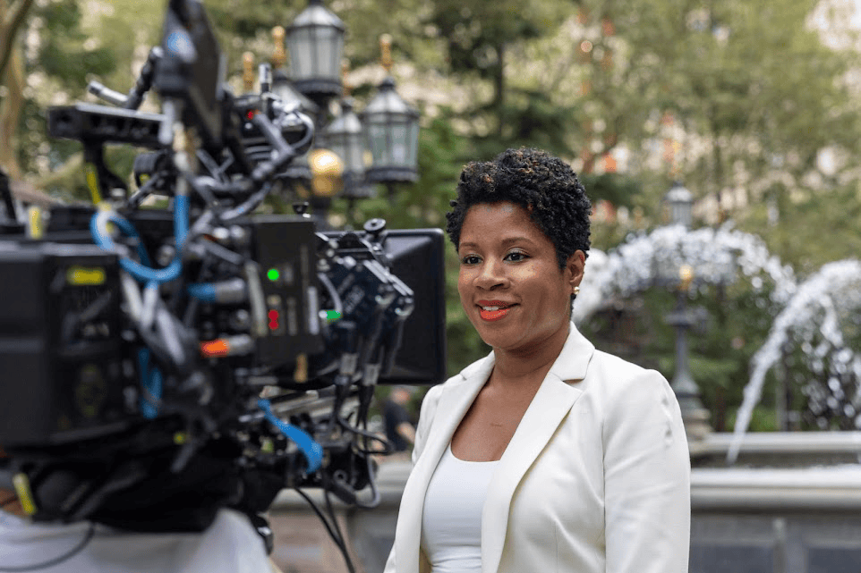 An image of a woman giving her testimonial on a camera