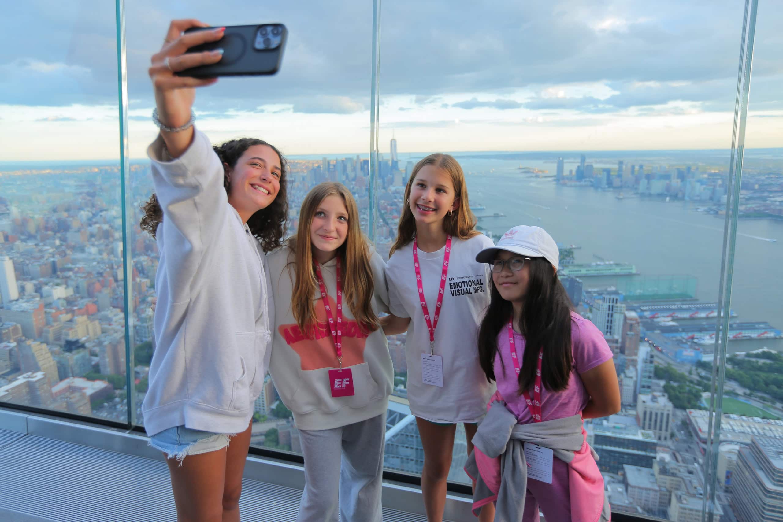 A group of young girls take a selfie at The Edge overlooking New York City