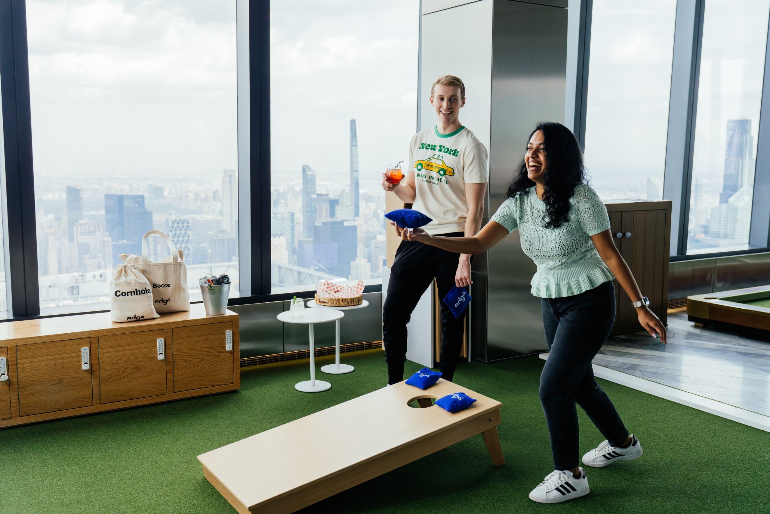 A woman laughs while playing lawn games at The Edge