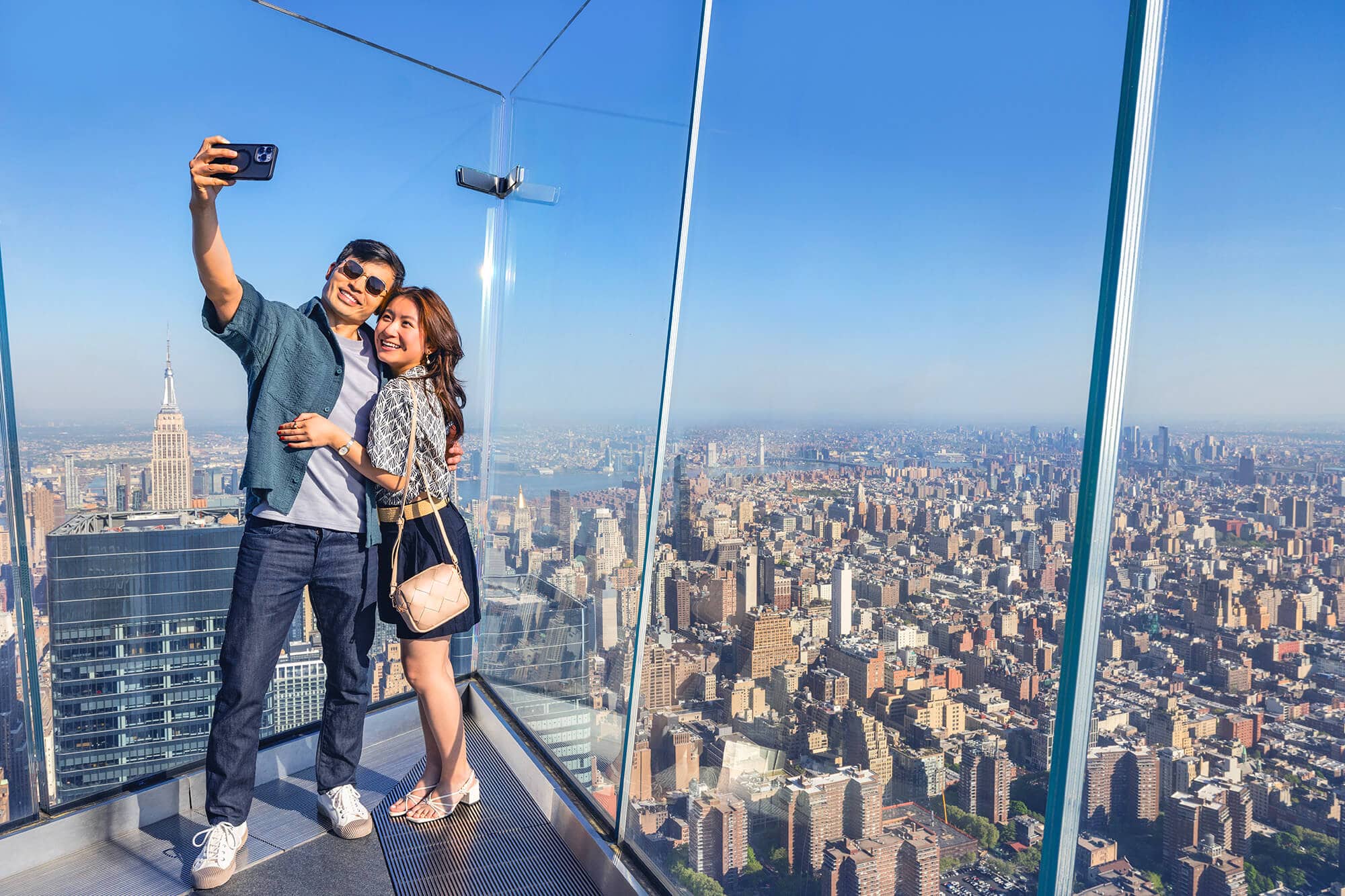 A couple takes a selfie at The Edge overlooking New York City