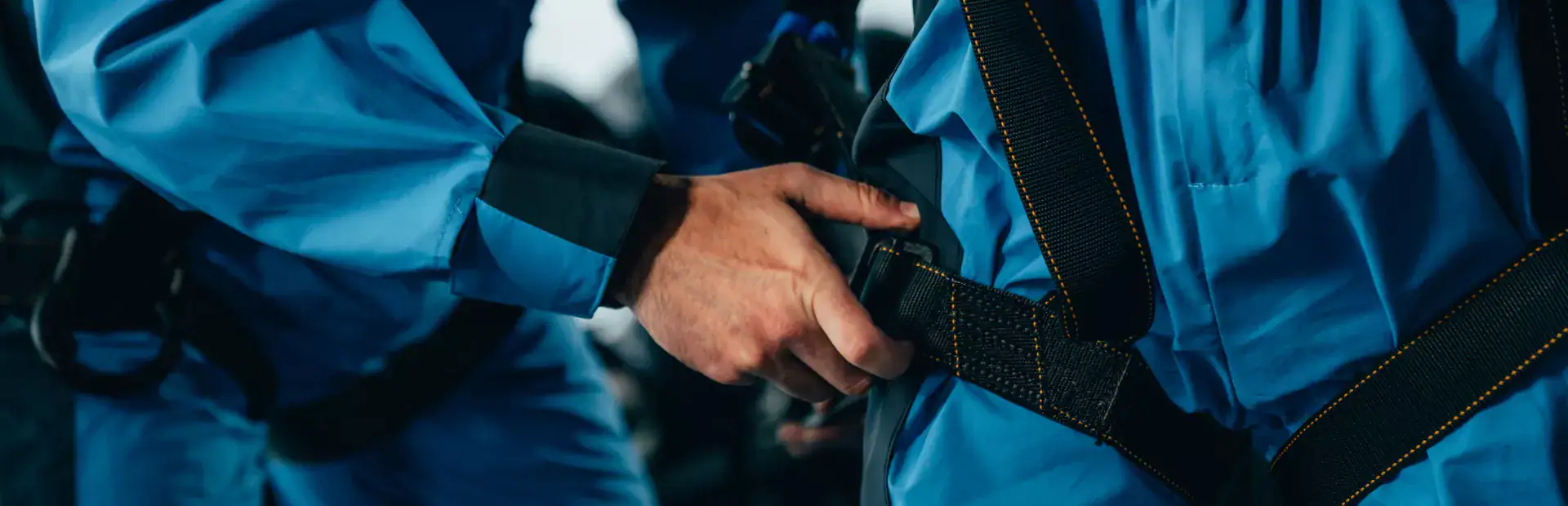 A City Climb worker adjusts the safety gear on a guest at The Edge