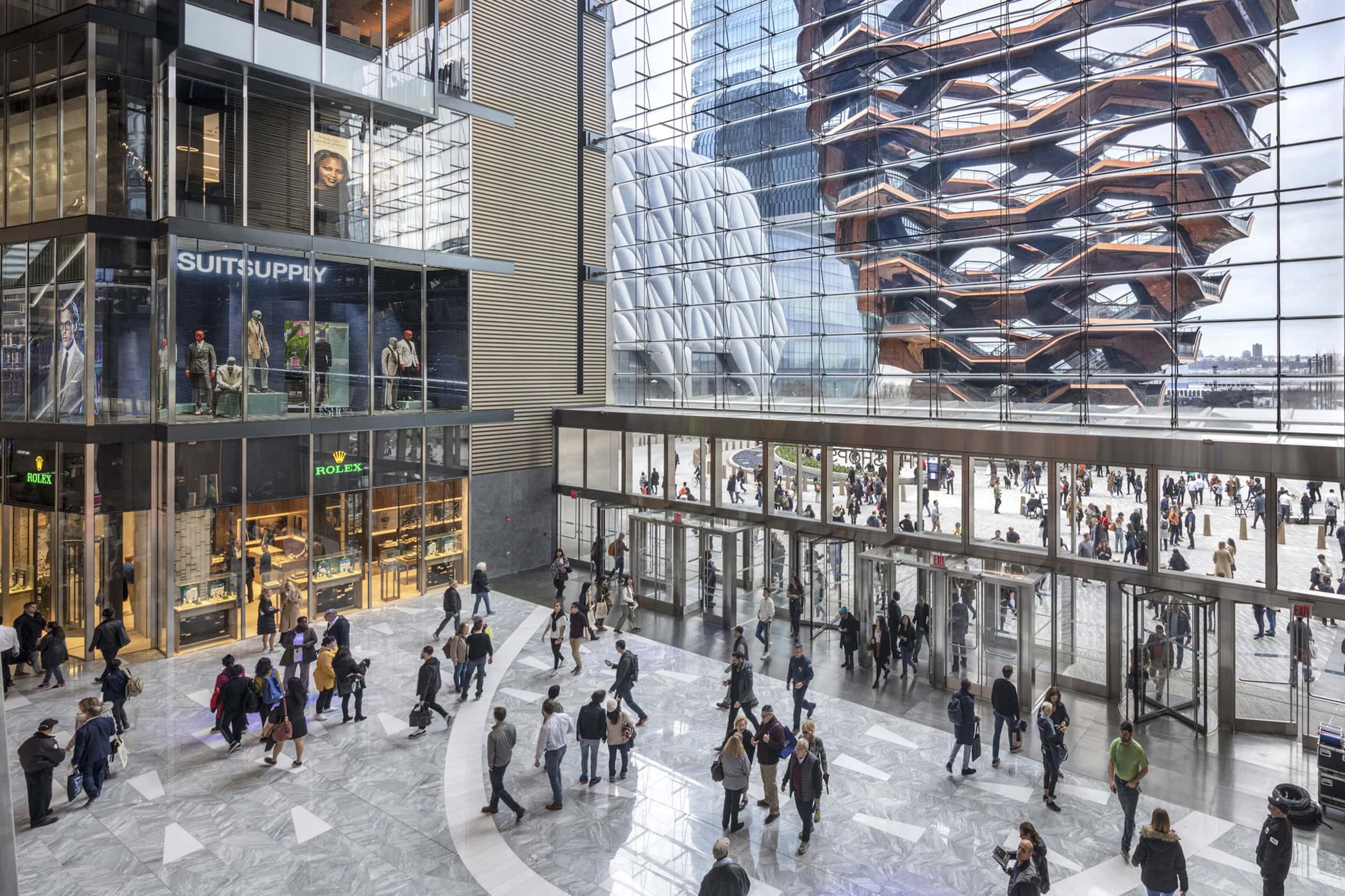 The interior of Hudson Yards shops, floor to ceiling windows overlooking Vessel