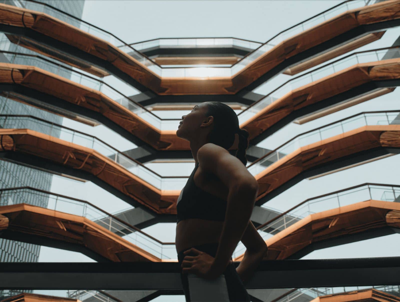 woman looking up inside at the vessel nyc
