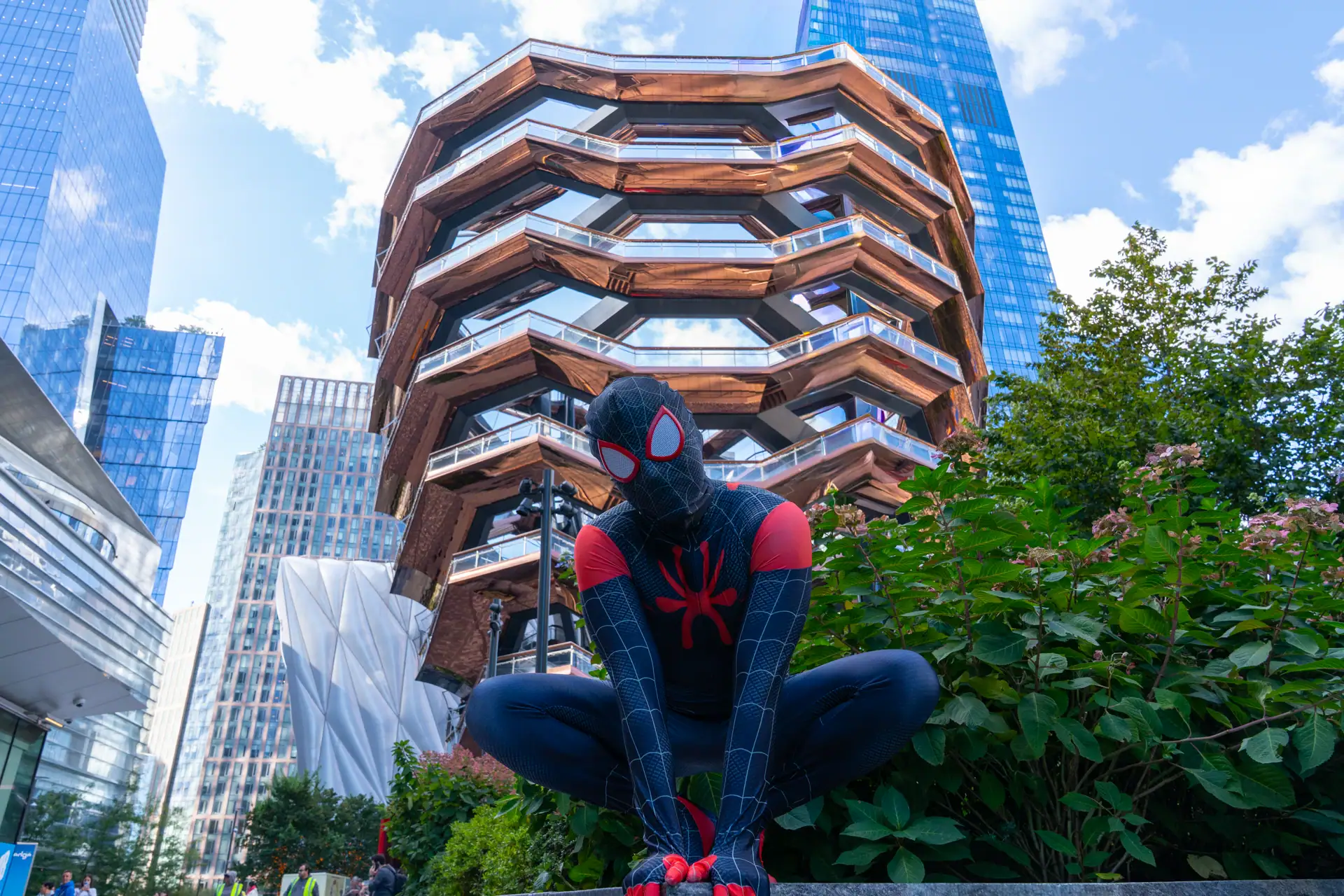 spider man posing in front of The Vessel in NYC