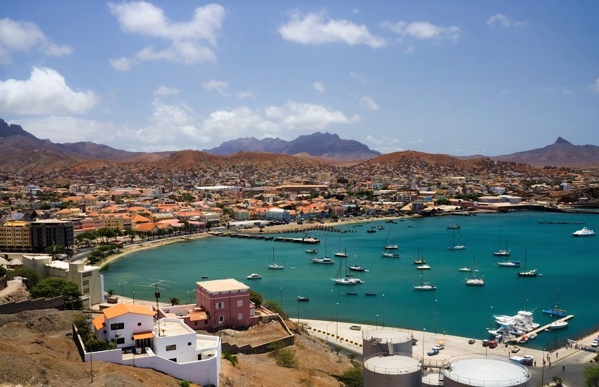 A view of São Vicente town with colourful buildings set against a backdrop of hills.