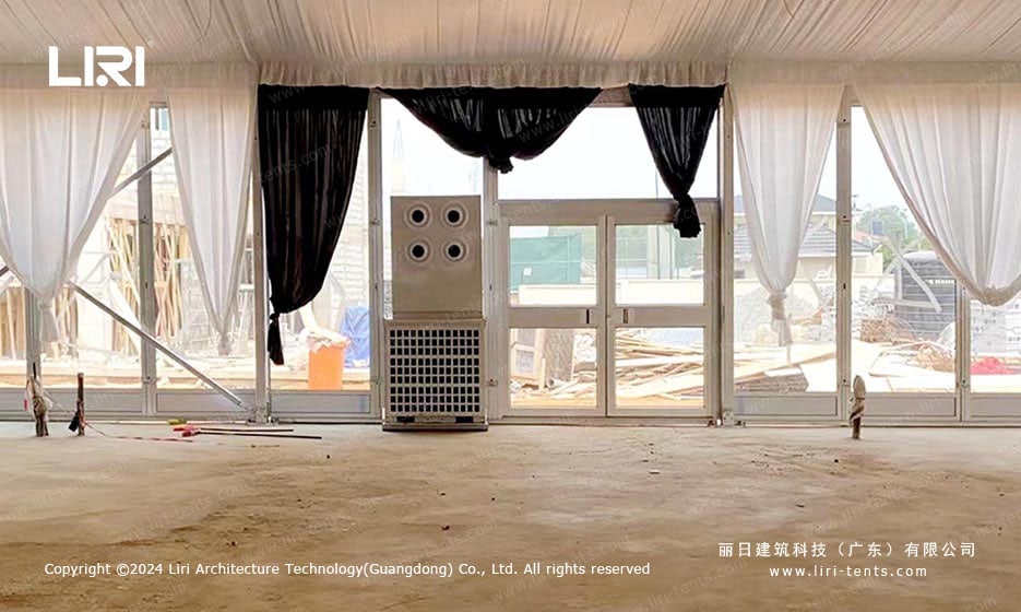 Side view of aluminum frame event marquee with full glass wall at Ghana hotel