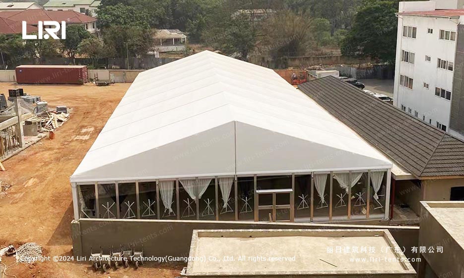 Interior of event tent with black and white curtains and air conditioning