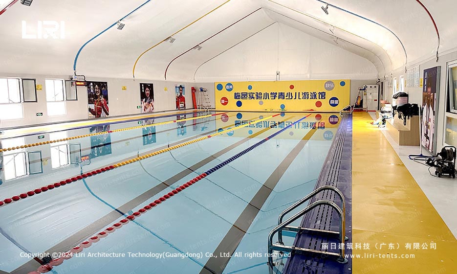 Indoor swimming pool tent with pool lanes and deck