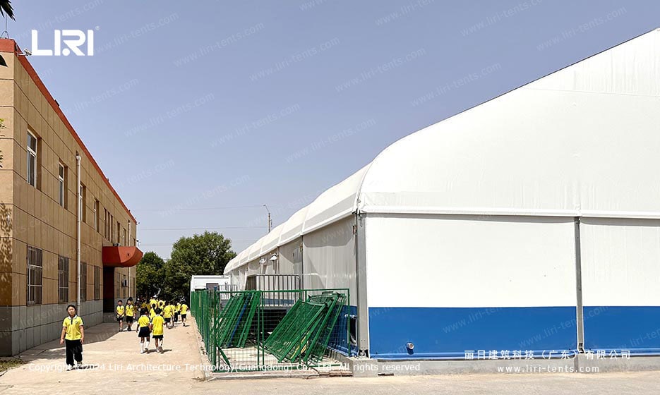 School natatorium tent exterior with white canopy and blue base
