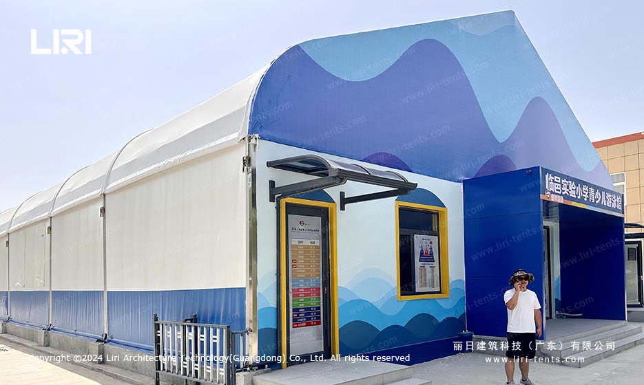 Swimming pool tent entrance with blue wave graphics