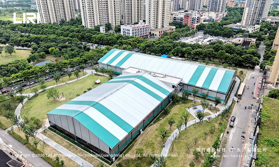 Aerial view of clear span event tent complex in urban park setting