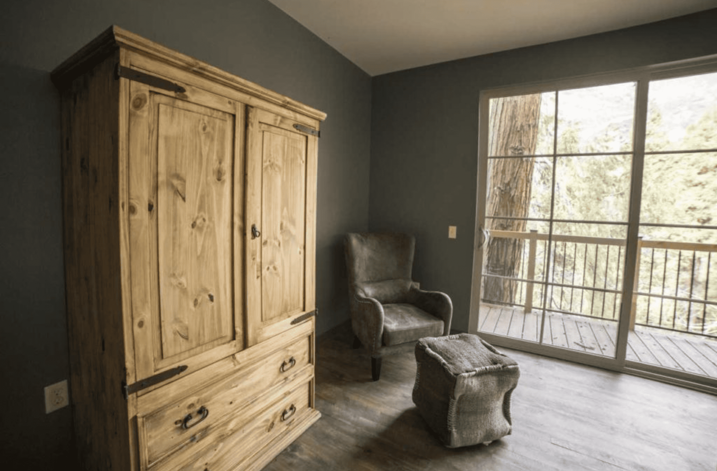 Room with wardrobe and chair with ottoman