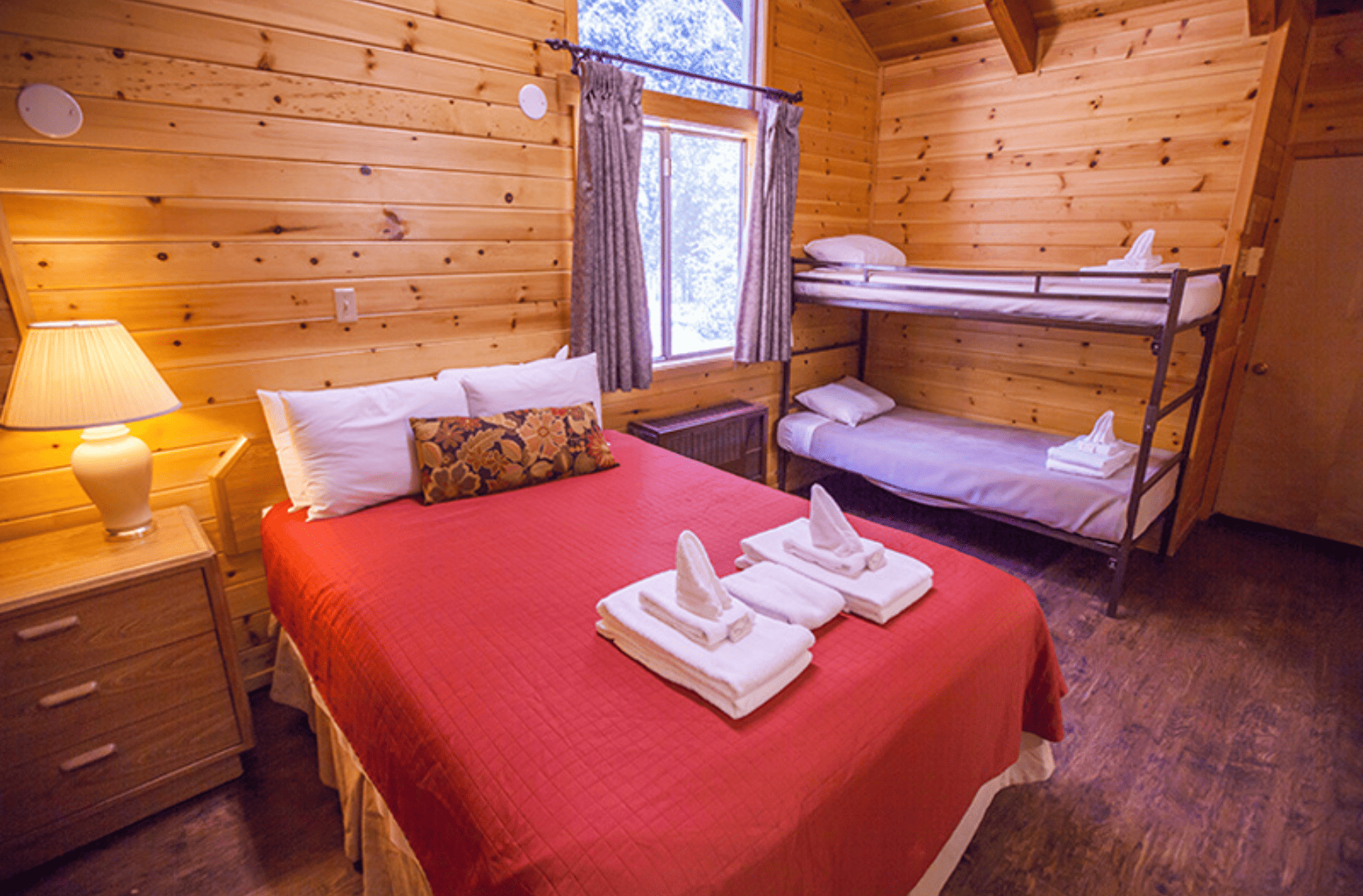 Room in cabin with a bunk bed and queen bed