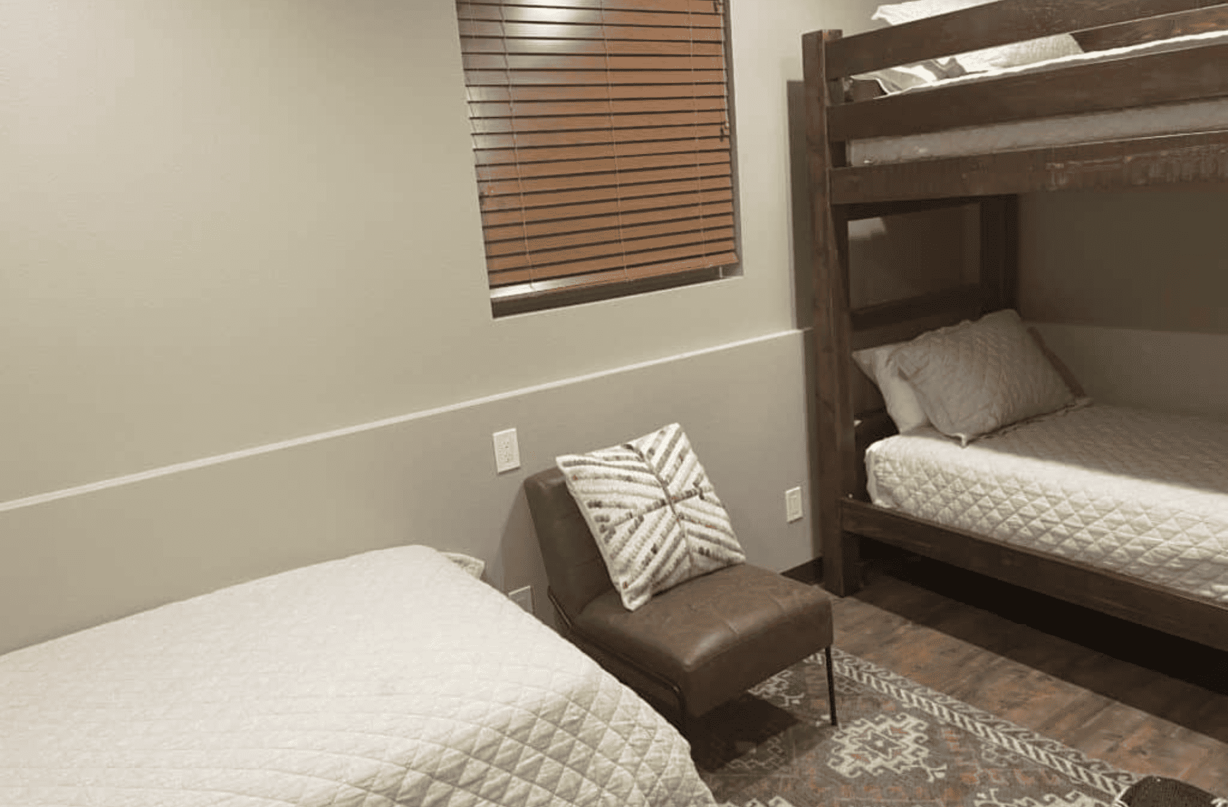 A twin size mattress with a bunk bed and a chair in the middle