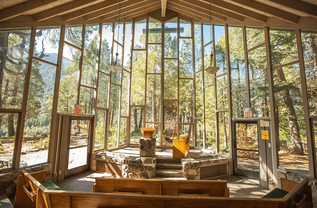 Inside the prayer chapel with windows looking over the forest