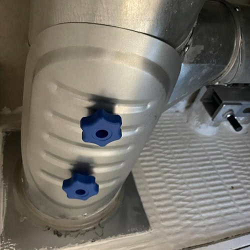 An oval fire damper inspection hatch.