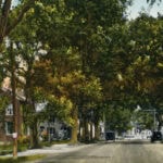 Harrington House is the brick structure on the left in this ca. 1925 photo.