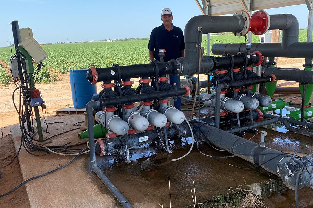 Mike Patschke with his Netafim drip irrigation system. He says the cost is $1,200/acre for the drip irrigation product, the supplies, and the labour. - Photo: Netafim