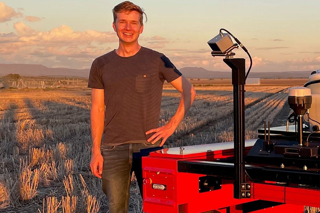 Guy Coleman on University of Sydney’s farm in Narrabri, New South Wales, next to the research station’s Digital Farmhand robot. - Photo: Khalid Rafique