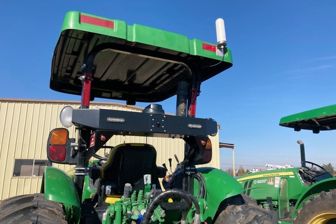 Sensors and cameras are mounted at the back of the tractor.