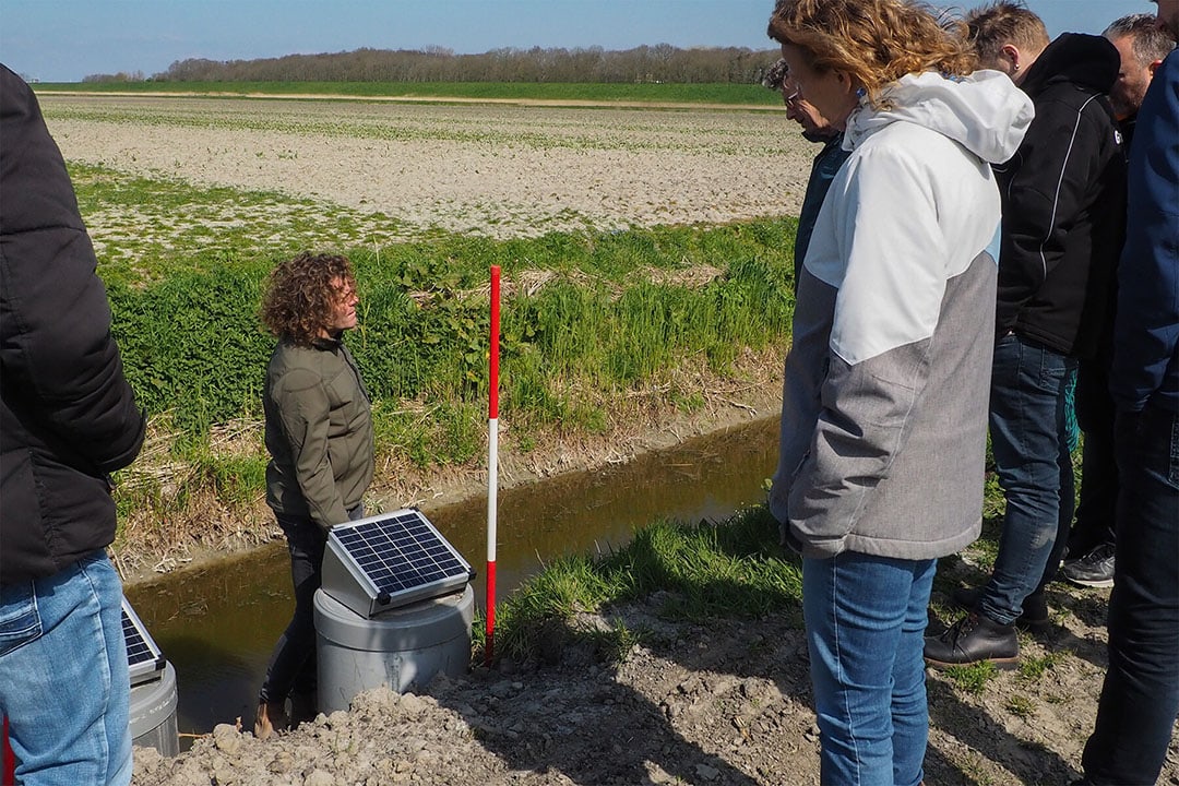 Farmer Klaas Schenk explains the water management system during a field visit.