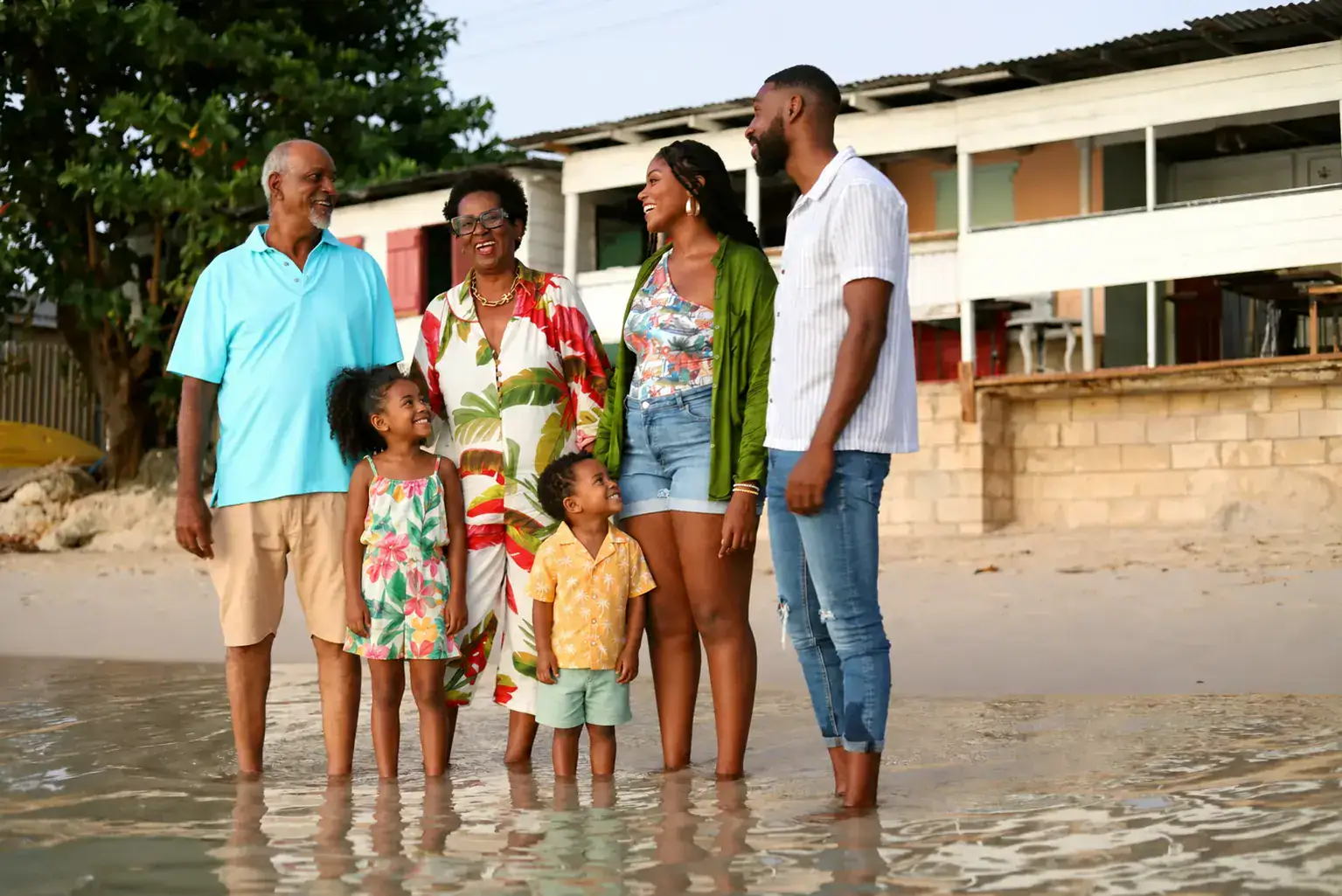 A multigenerational family enjoying the shoreline in Barbados