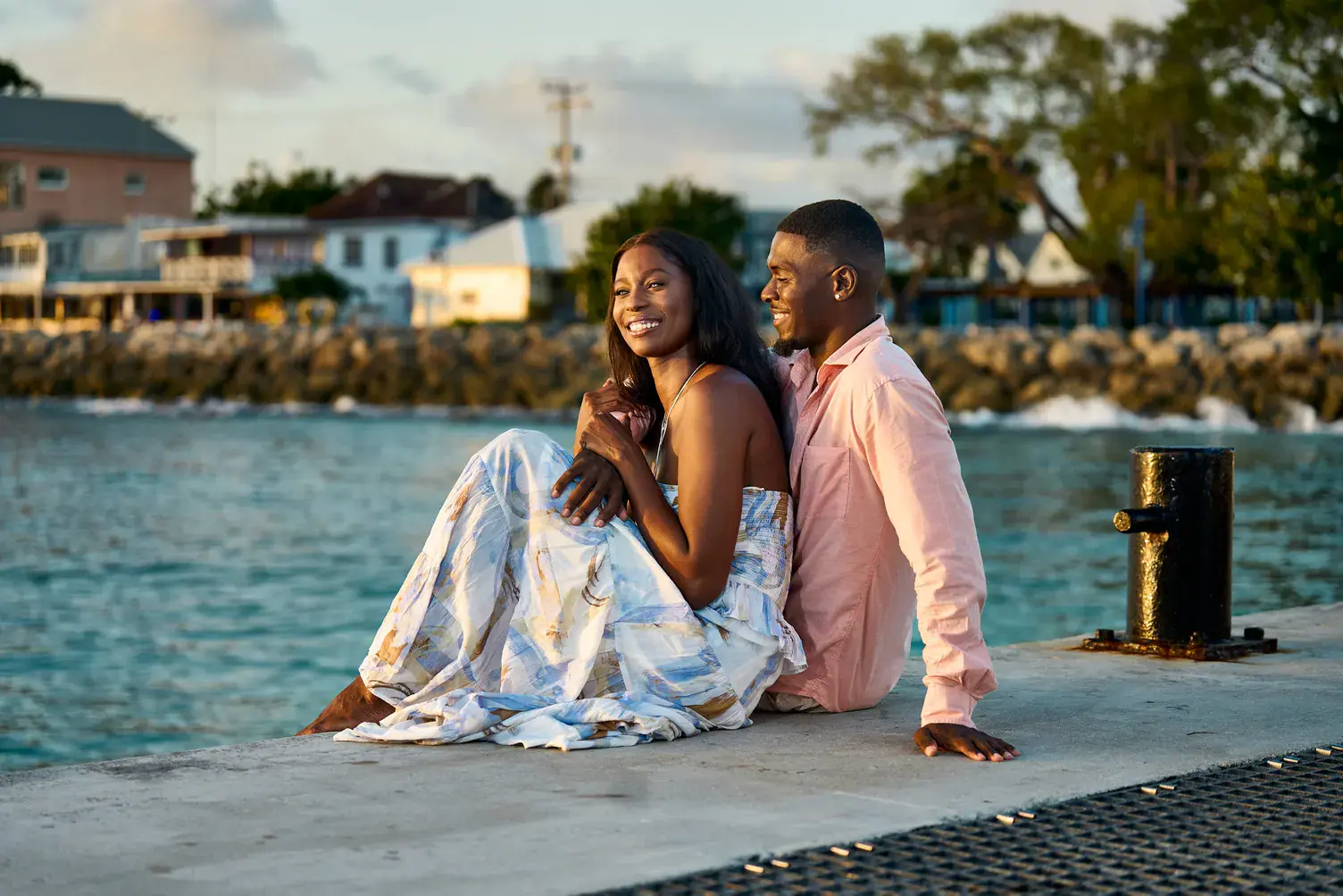 A couple relaxing together on the waterfront in Speightstown, Barbados