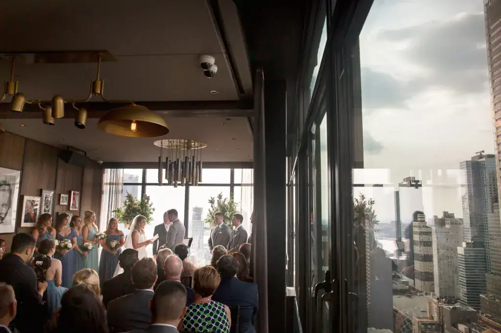A wedding ceremony at the top of a building with a view of the city at The Skylark.