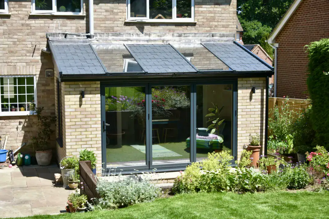 Single storey extension with bifold doors open onto a garden in Newbury