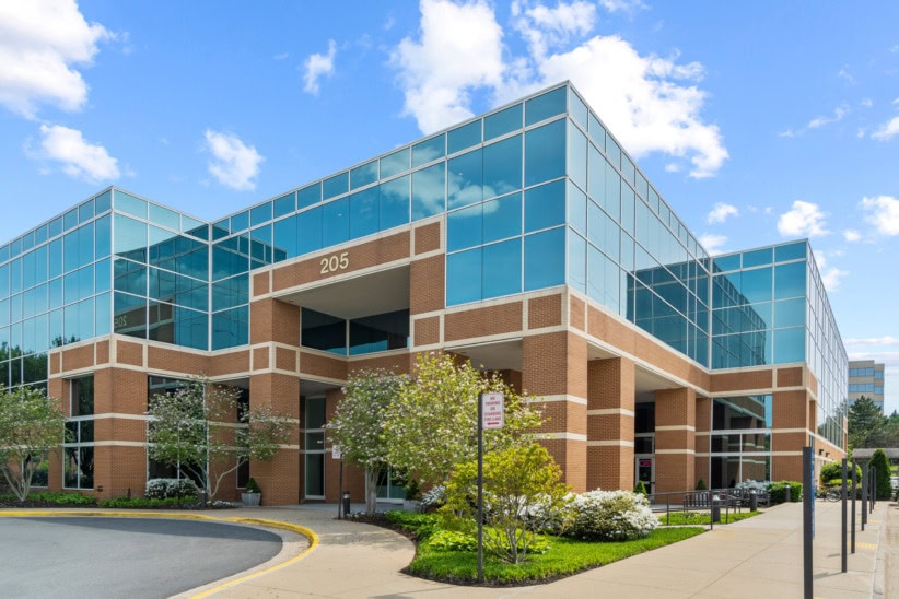 Modern office building with glass windows and brick facade for flexible workspaces at Office Evolution.
