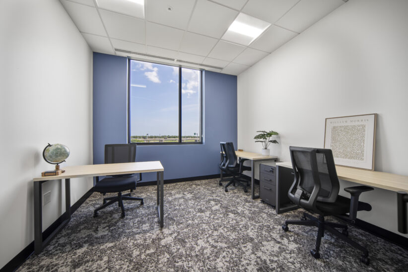 Modern office workspace with desks and ergonomic chairs at Office Evolution.