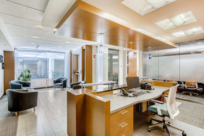 Modern office reception area with seating and workspace, ideal for professional business environments at Office Evolution.