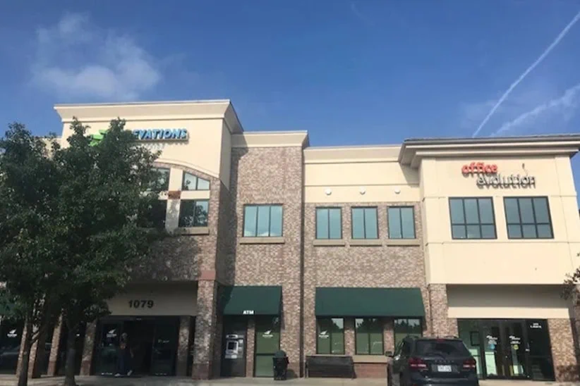 Modern office suites & coworking spaces at Office Evolution in a professional business park setting.