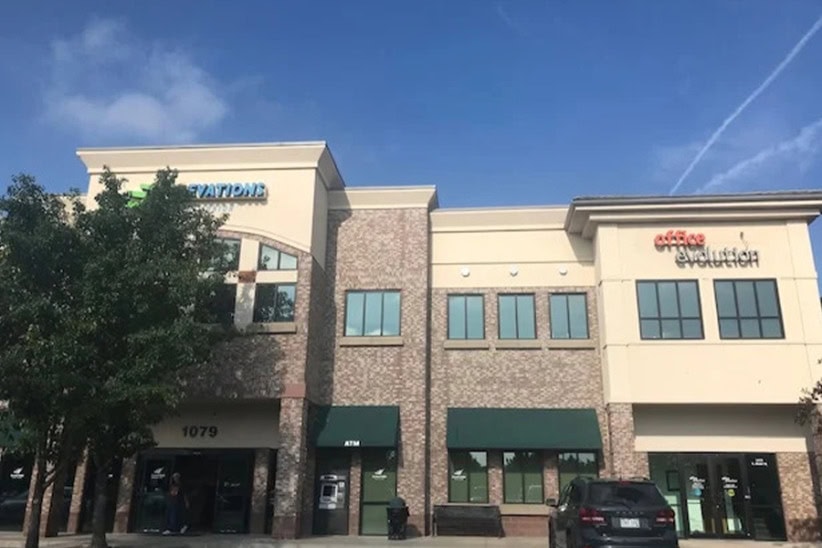 Modern office space in a commercial building with co-working and private office options.