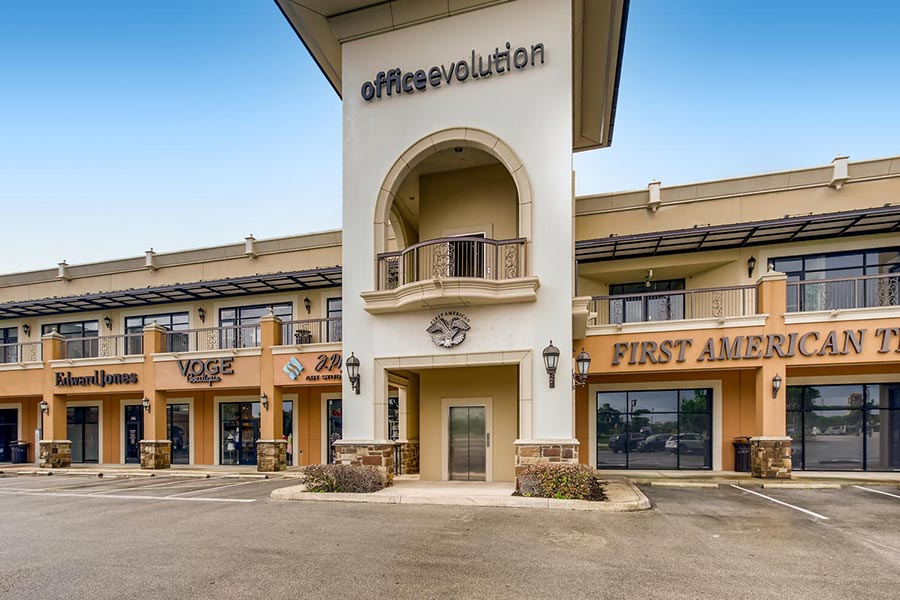 Office evolution coworking space exterior with retail shops and commercial offices.