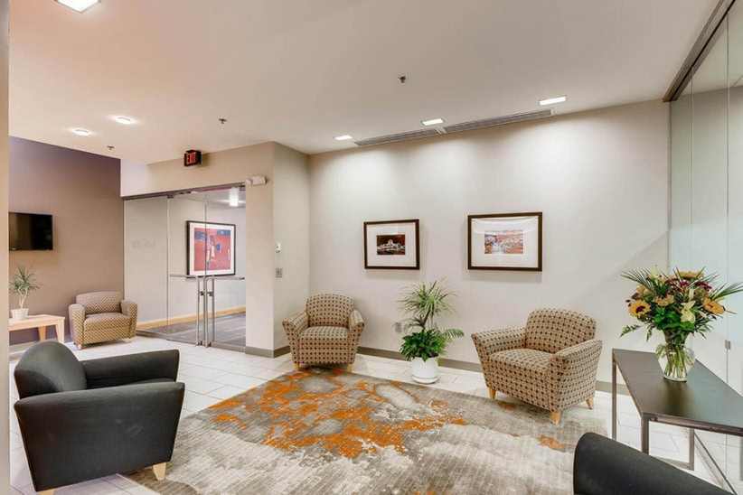 Cozy office lounge with modern seating and artwork for business tenants.