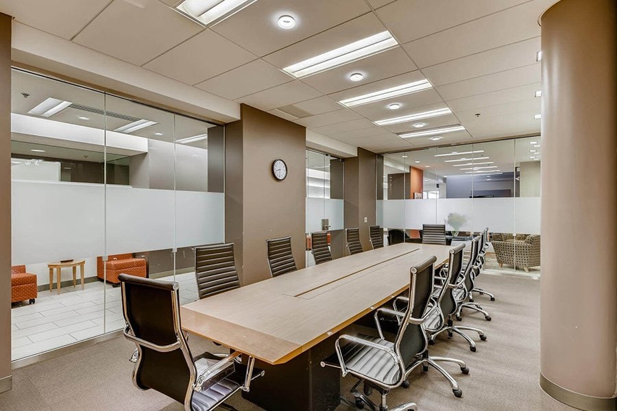 Modern corporate meeting room with glass walls and ergonomic chairs at Office Evolution.