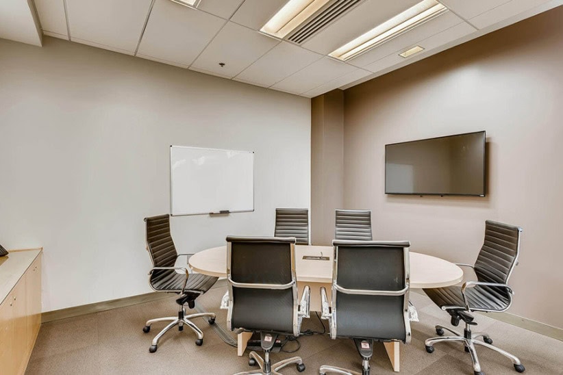 Office evolution professional conference room with modern chairs and TV for meetings.