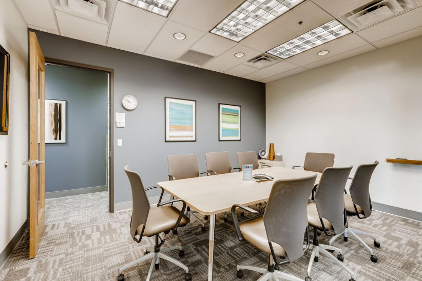 Modern conference room with office chairs and meeting table at Office Evolution facility.