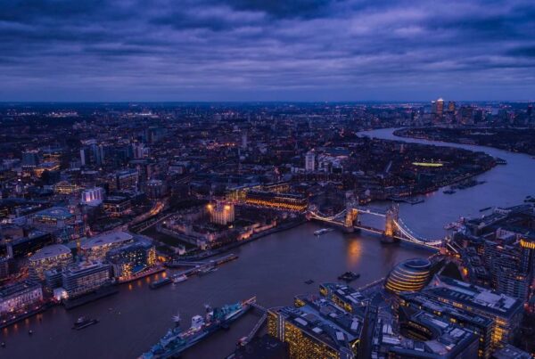 View of London with Tower Bridge and city lights in the background.